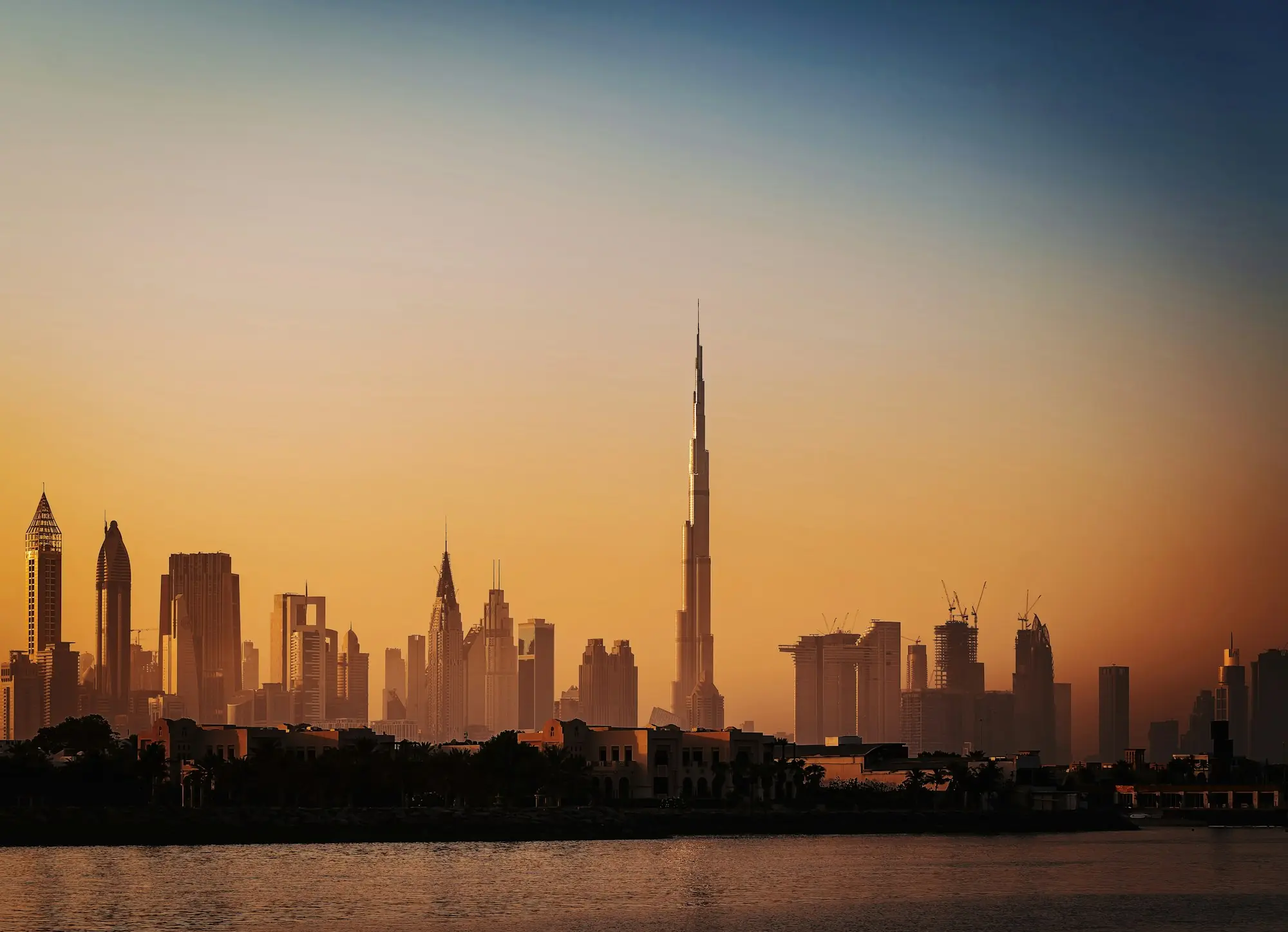 A city skyline at sunset across the water